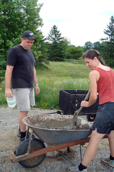 Mixing concrete in a wheelbarrow