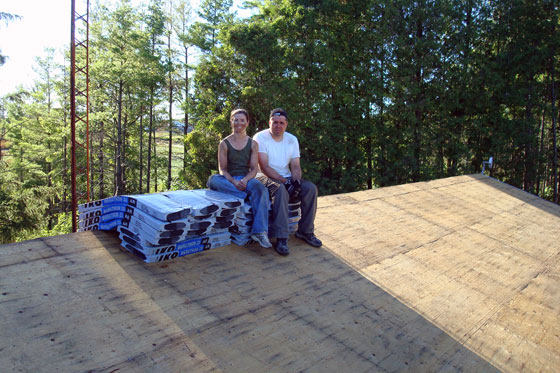 roofday1a Bundles of shingles on a plywood roof