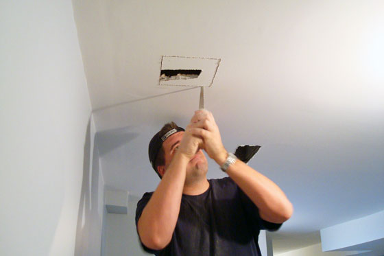 Matt cuts the hole in the ceiling