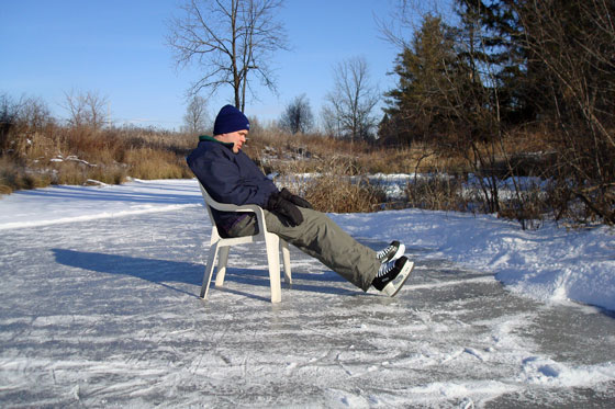 Taking a skating break in a lawn chair on the ice