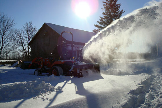 Clearing the driveway with the snowblower on the tractor
