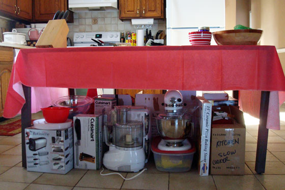 Metal patio table with appliances stacked underneath
