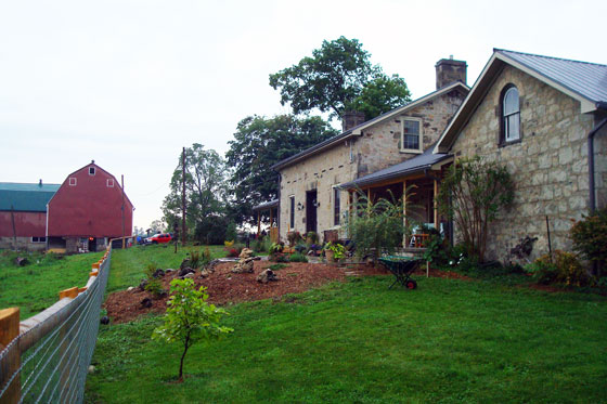 Stone farmhouse and red barn