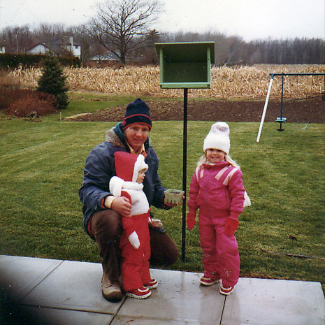 Putting seed in a simple wood birdfeeder