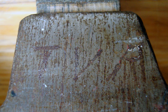 Initials carved into a hammer head