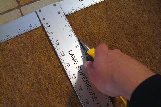 Cutting a rug using a drywall square
