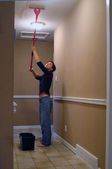 Mopping the ceiling to prepare for painting