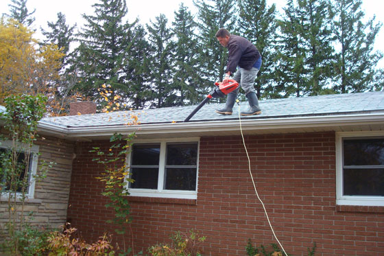 Cleaning gutters with a leaf blower
