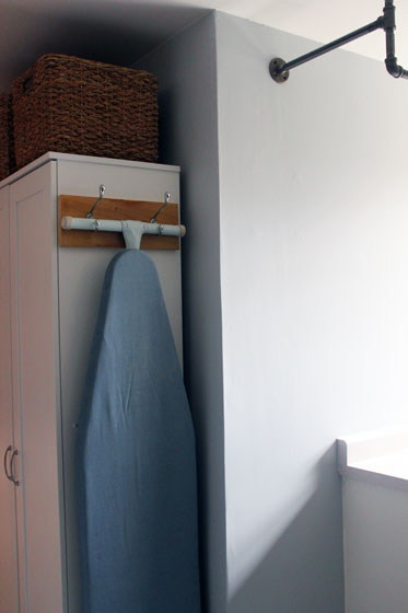 Hanging ironing board in the laundry room