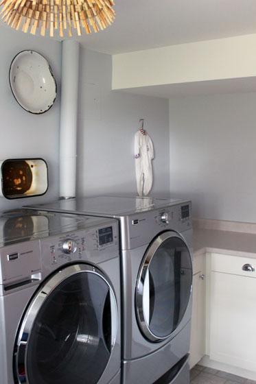 Enamel basins and infant sleepers hanging in the laundry room