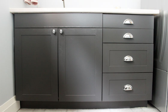 Black shaker cabinets with chrome cup pulls and knobs