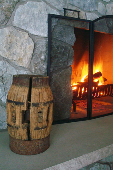 Old wagon wheel hub on a stone fireplace hearth