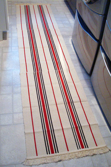 Three Ikea Signe rugs made into a runner in the laundry room