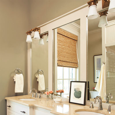 Dress up a plain mirror that's adhered to the wall by overlaying a wood frame
