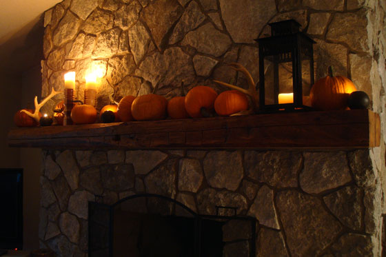 Candles lit on the fall mantel