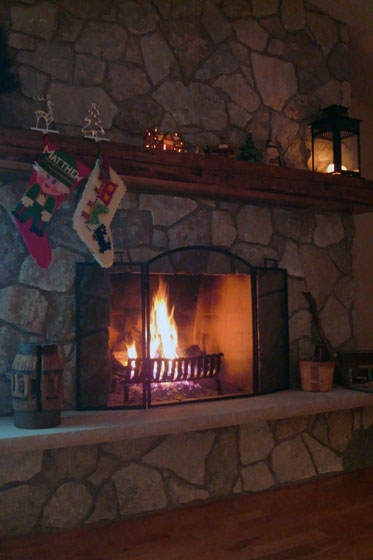 Stone fireplace decorated for Christmas