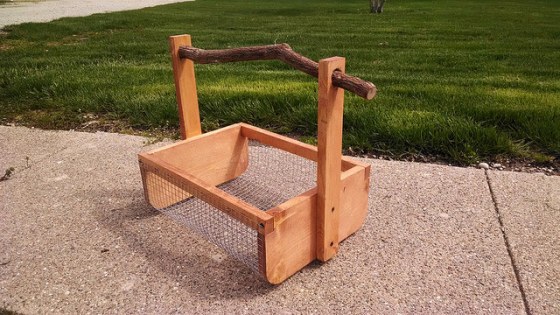 Wooden vegetable harvest basket with a twig handle
