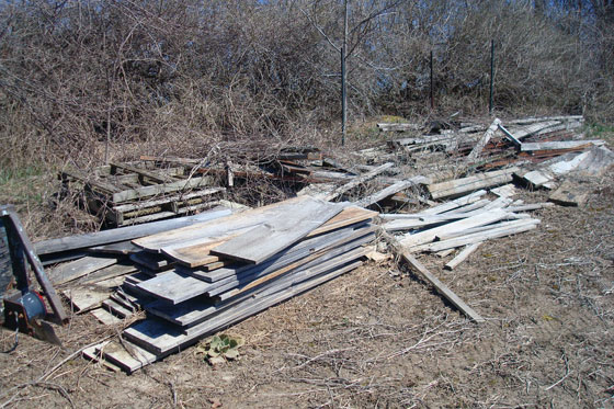 Lumber pile at the edge of the field