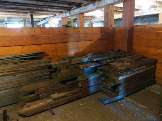 Lumber piled in a horse stall
