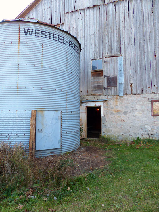 Lumber pile cleaned up beside the silo