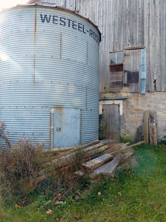 Lumber piled outside the barn
