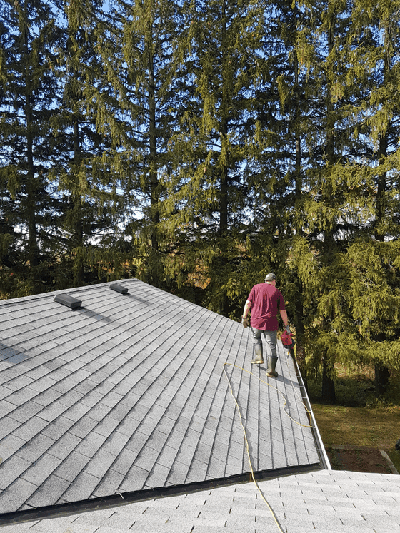Matt cleaning the gutters with the leaf blower