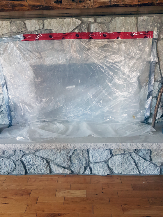 Covering the fireplace to prevent dust during chimney sweeping