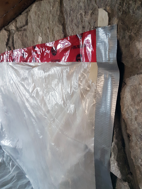 Covering the fireplace to prevent dust during chimney sweeping