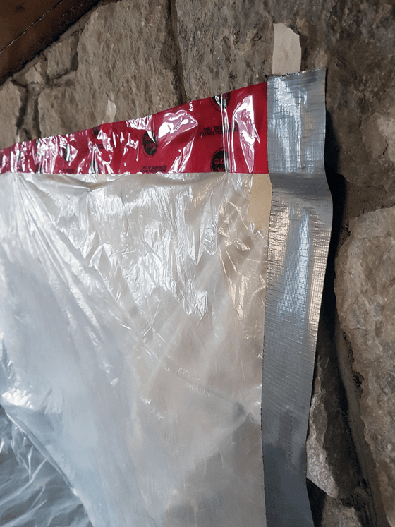 Covering the fireplace to prevent dust during chimney sweeping