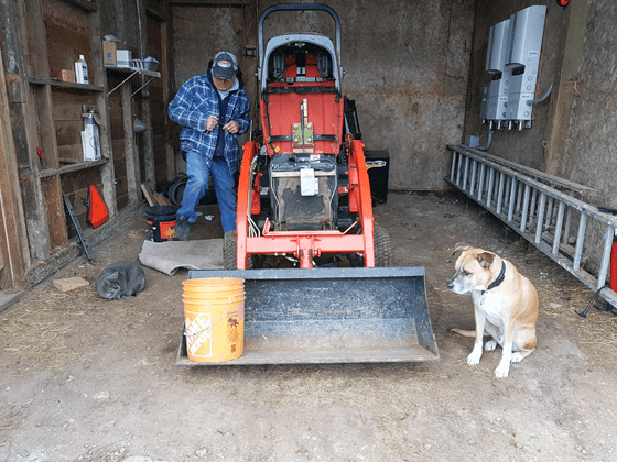 Ralph and Baxter supervising the oil change on the tractor