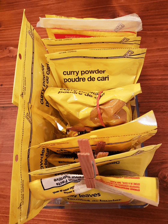 Bags of spices organized in a bin