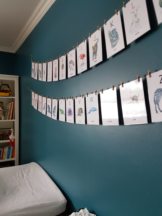 Alphabet flashcards above the changing table