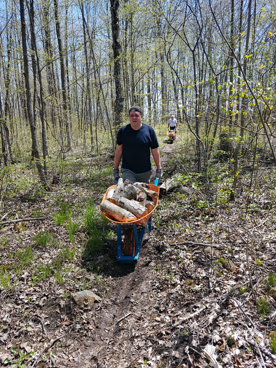 Matt and his Dad wheeling firewood out of the woods