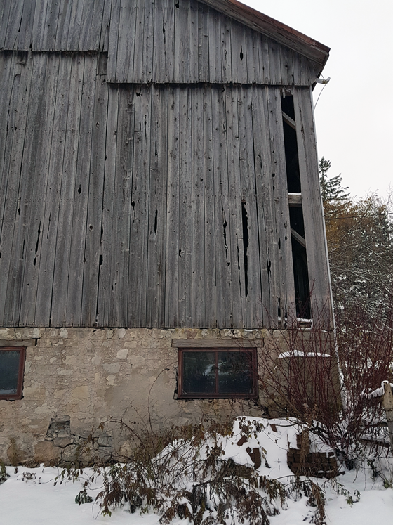 Patching wood siding on a barn