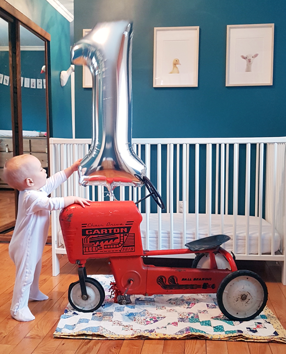Baby with tractor pedal car