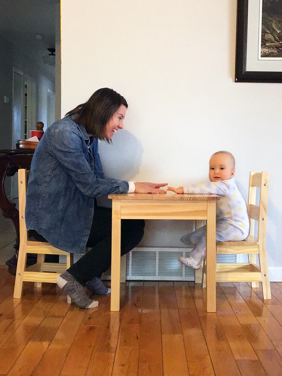 Mom and baby sitting a child size table