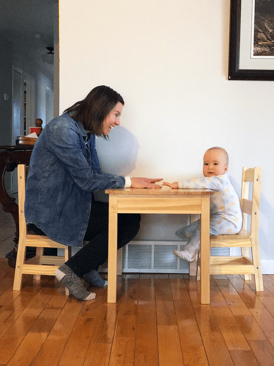 Mom and baby sitting a child size table