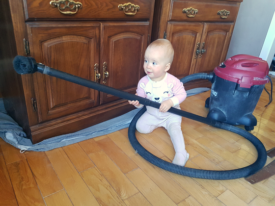 Ellie vacuuming in the dining room