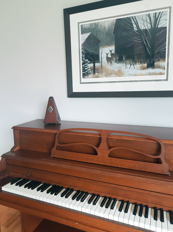 Deer painting above a piano