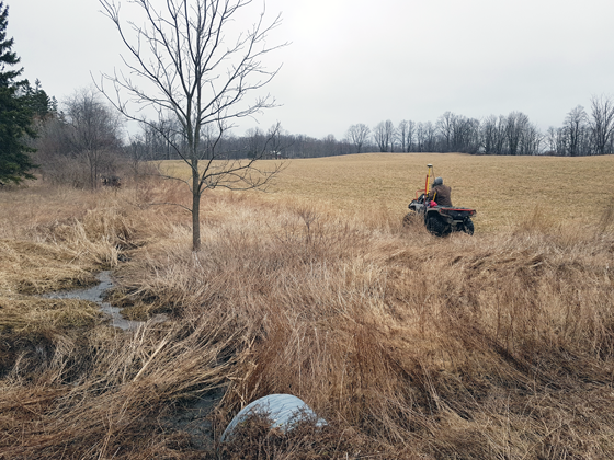 Surveying the field by ATV to prepare for tiling