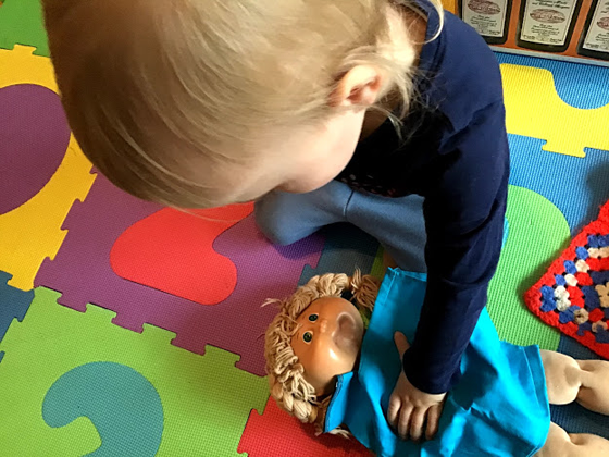 Ellie playing with a cabbage patch doll