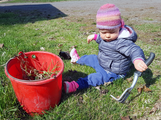 Ellie gardening at 1 year old