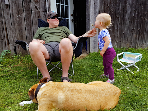 Matt and Ellie blowing dandelions