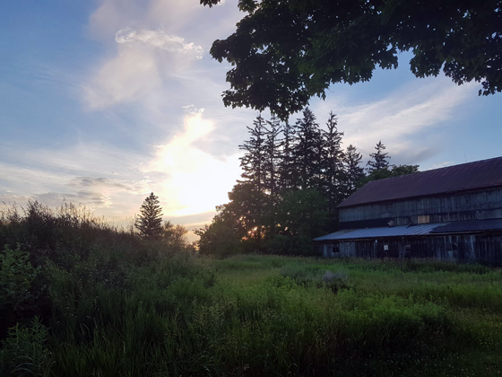 Barn with solar panels at sunset