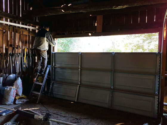 Installing a new garage door on the small barn