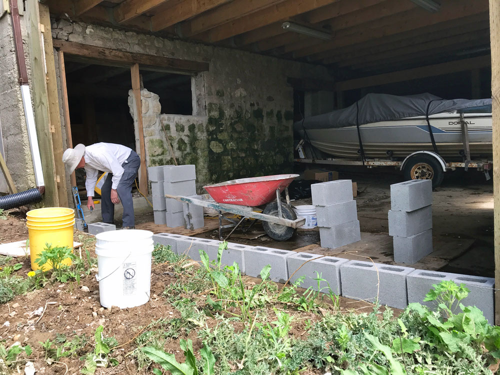 Mason building a wall with concrete blocks